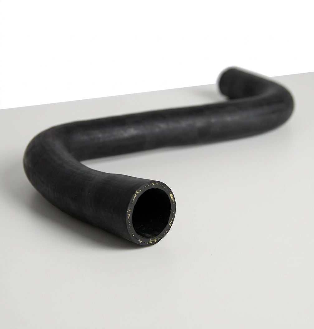 Smooth black rubber hose with an S-shaped bend, studio shot on white
