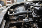 Return hose fitted from steel pipe to water pump on a stripped Triumph TR7