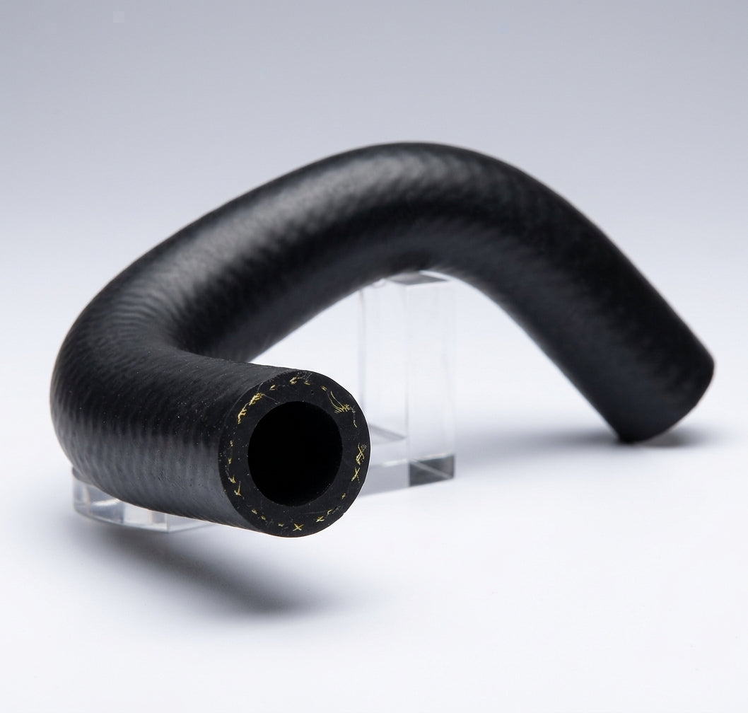 S-shaped black ribbed heater hose on a clear stand, studio white background