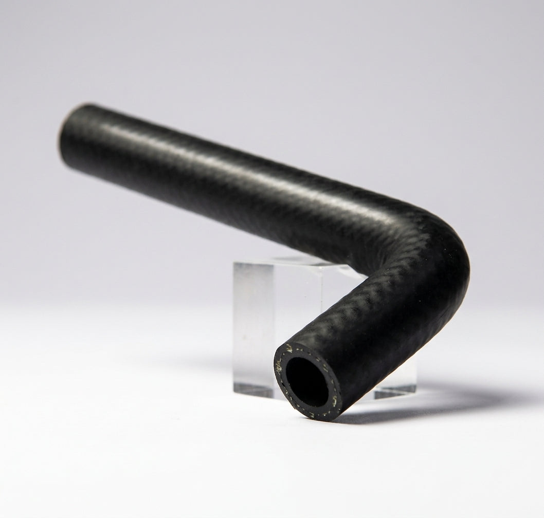 Black heater hose bent at a right angle, studio shot on stand
