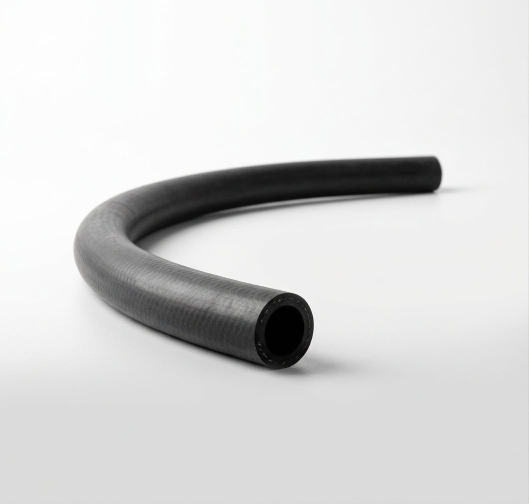 Curved black rubber hose on white background, studio shot