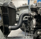 Right-hand bottom radiator hose fitted in situ between radiator and engine