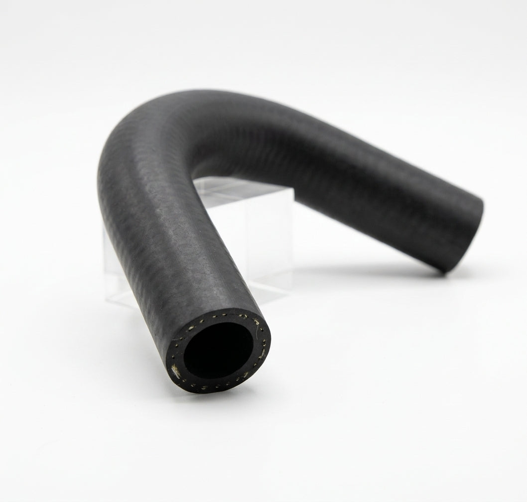 Black ribbed rubber bleed hose bent into shape, studio shot on a stand
