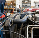 Black bleed hose fitted to a radiator in a classic car engine bay