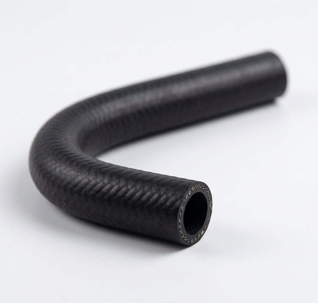 Black textured heater hose curved into a tight loop, studio shot