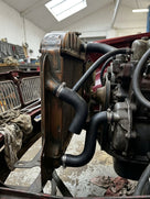 Moulded black rubber radiator hose with side branch, shown end-on against white background