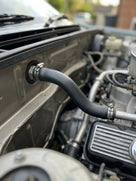 Hose fitted with jubilee clips in the engine bay of a classic car