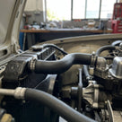 Right-hand radiator hose fitted in situ under an open bonnet