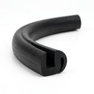 Curved length of black rubber S-shaped glazing channel, end-on view