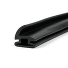 Black rubber hinge pillar seal with curved fin and hollow leg, coiled on white background