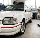 White Escort Mk4 with red bumper trim fitted along the lower body edge