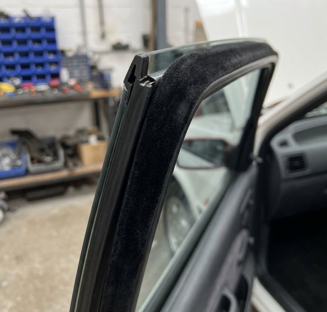 Flocked black inner waist strip fitted along a car's window frame edge