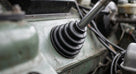 Steering column gaiter fitted in the engine bay of a green classic Jaguar