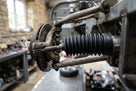 Steering rack gaiter fitted near the front hub of a classic Jaguar's suspension