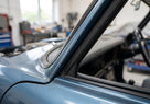 Door seal fitted along the frame of a blue classic Jaguar saloon