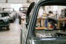 Door seal fitted along the rear window frame of a dark green classic Jaguar saloon