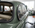 C-post seal fitted along the rear door and quarter window of a green classic Jaguar saloon