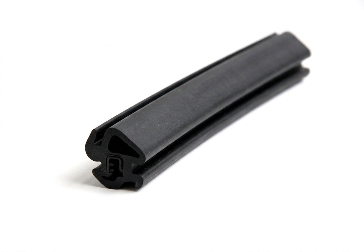 Black rubber seal with barbed leg, curved length on white background