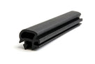 Black rubber door seal with barbed leg and hollow bulb, coiled on white background