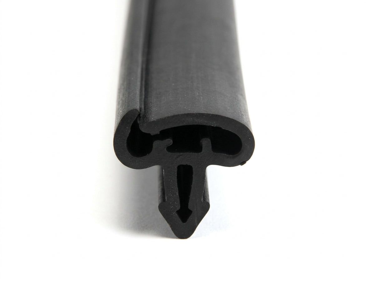 Black rubber door seal with barbed mounting leg, angled length shot on white background