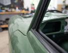 Moulded door seal fitted where the door meets the hardtop of a green classic Jaguar E-Type