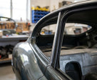 Door seal fitted along the rear quarter window of a grey classic Jaguar E-Type