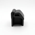 Black rubber cant rail seal with curved cap and hollow leg, upright studio shot