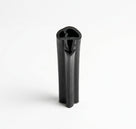 Cut end of black rubber door frame seal showing hollow channel with barb, upright studio shot