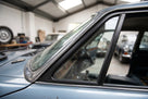 Front quarterlight seal fitted to the A-post window frame of a blue classic Jaguar saloon