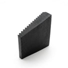 Black fluted rubber matting viewed end-on as a block, studio shot on white