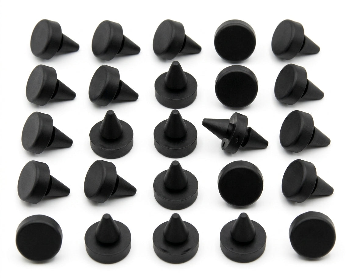 Black cone-shaped bonnet buffers laid out in rows, studio shot