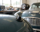 Black bonnet buffer fitted to a classic car's bonnet edge