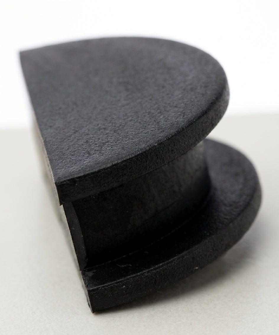 Black rubber cambox end plug shown side-on, stepped disc profile