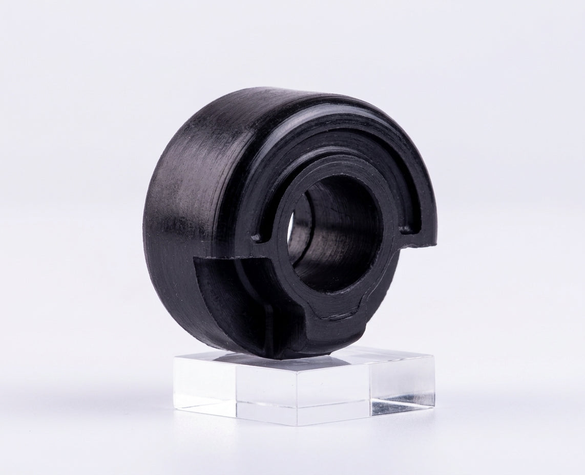 Black rubber seat buffer with central hole, angled studio shot on stand