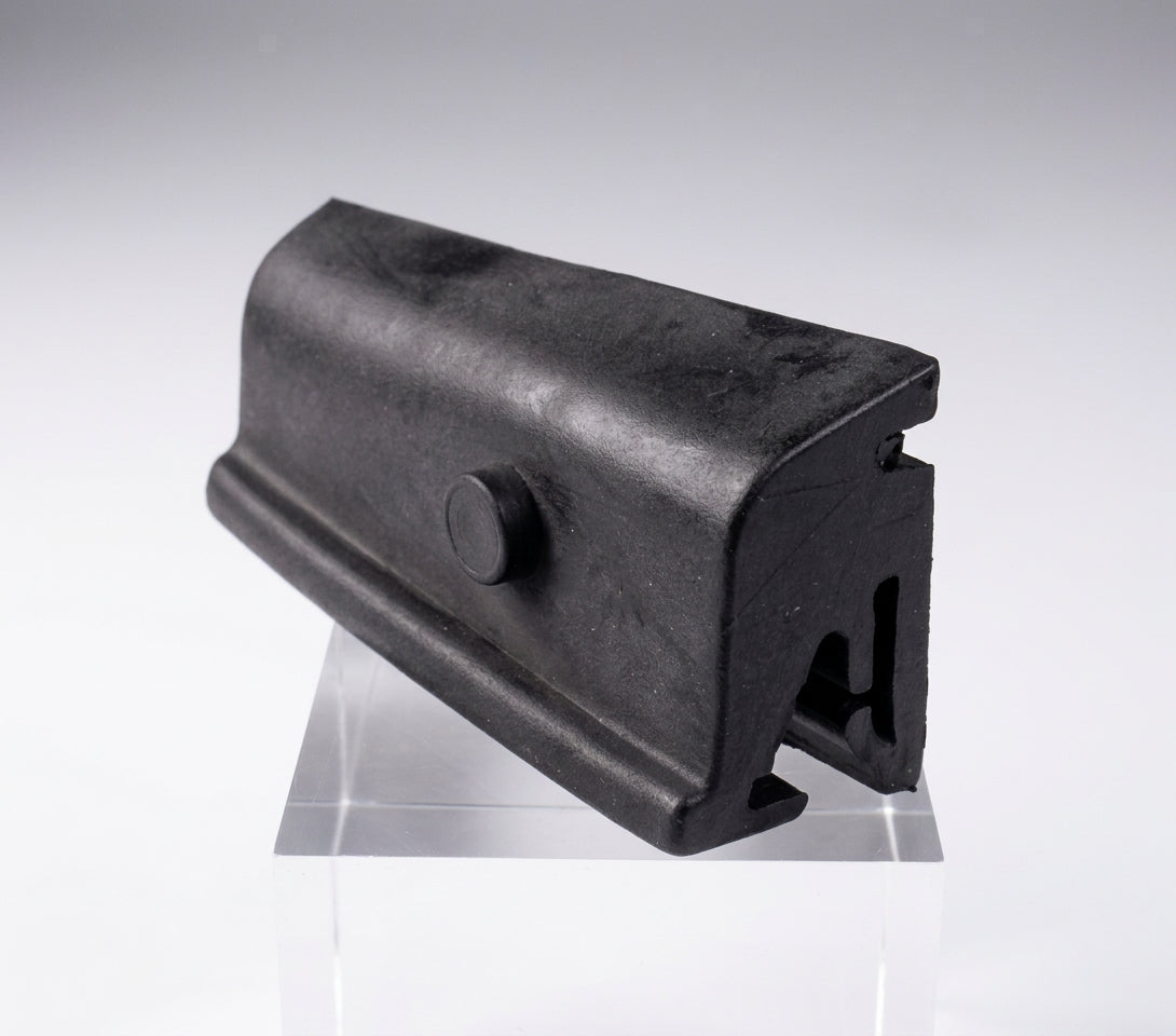 Black moulded door buffer on a stand, angled studio shot