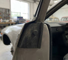 Door buffer fitted to the door pillar of a silver Triumph, close-up