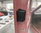 Door buffer fitted to the door pillar of a pink Triumph, close-up