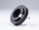 Black ridged rubber gearbox linkage bush, angled studio shot on stand