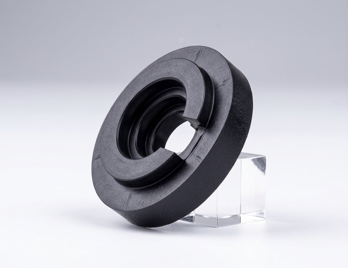 Black ridged rubber gearbox linkage bush, angled studio shot on stand