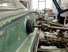 Gearbox selector linkage bush fitted through a green Triumph's bodywork