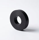 Black rubber mounting ring with a central hole, studio shot on white background