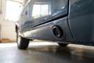 Plug fitted in the sill jacking point of a blue-grey classic car