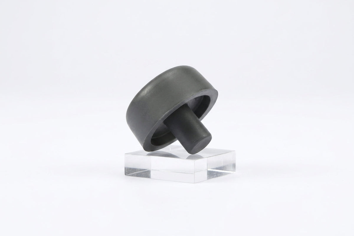 Grey rubber bonnet buffer with mounting stem, angled view on a stand