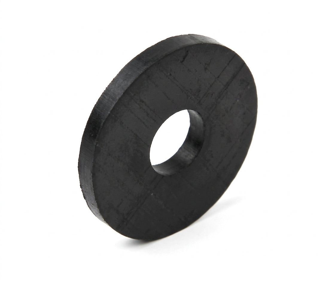 Black rubber differential mounting pad, angled studio shot of flat disc