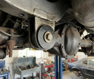 Black differential mounting pad fitted to a classic car's axle bracket