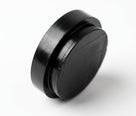 Round black insulator pad on white background, studio shot