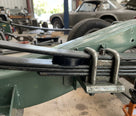 Black insulator pad fitted between leaf spring and chassis mounting in situ