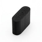 Short black sponge rubber block with rounded oval end face, studio shot showing porous texture