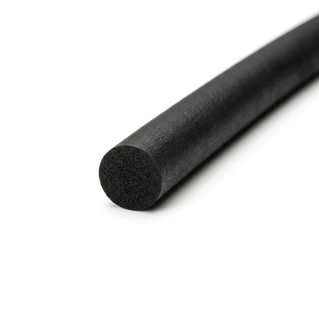 Black sponge rubber cord at an angle, close-up on the round cut end showing porous texture
