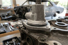 Black O-ring seated around a housing on top of an engine block